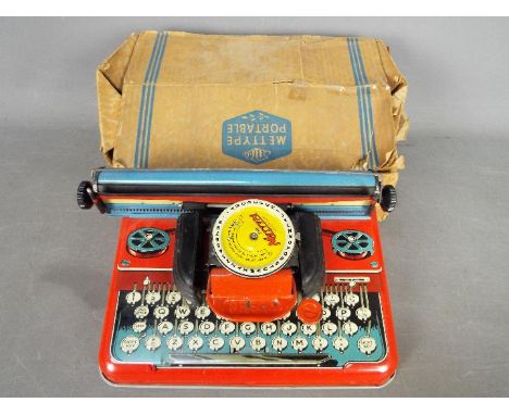 Mettoy - A boxed Mettoy Mettype 'Junior' Typewriter. The Typewriter show signs of play and use but appears to be in Good over