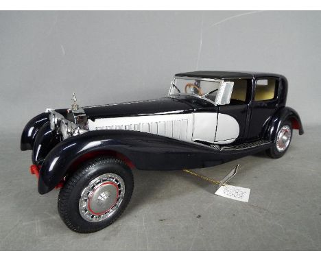 Franklin Mint - A boxed 1:16 scale 1931 Bugatti Royale Coupe De Ville by Franklin Mint. This impressive model in dark blue wi