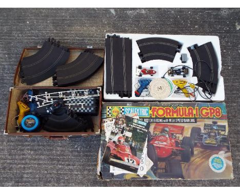 Scalextric - A boxed Scalextric Formula 1 GP8 set. The set contains 2 cars, hand controllers, track and some ephemera and app