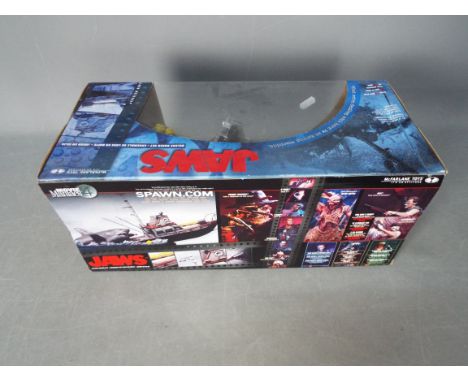 McFarlane Toys - Jaws - A boxed McFarlane Toys Jaws deluxe set. The box is still factory sealed and is dusty with some minor 