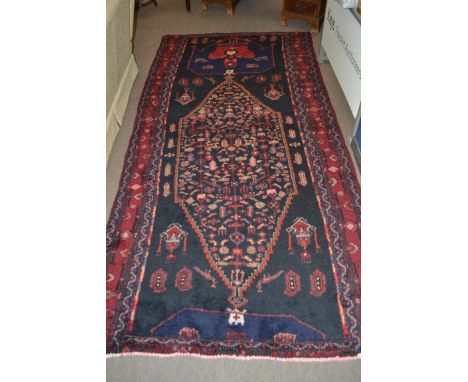 Vintage red ground Persian Tabreeze Carpet, bespoke medallion design surrounded by blue border 318cm x 150cm approximately&nb