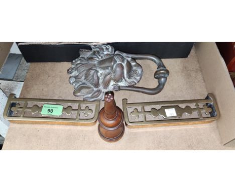 A brass lion mask door knocker; a pair of small brass trivets; an 18th/19th century boxwood glove powder pot 
