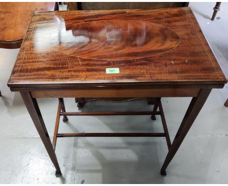An Edwardian inlaid mahogany rectangular fold over card table on square tapering legs, width 24" 