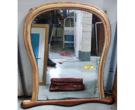 A shaped antique style over mantel mirror