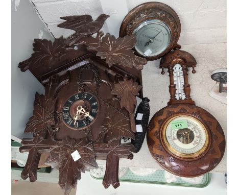 A cuckoo clock; 2 aneroid barometers with thermometer; a miniature grandfather clock and table lamp 