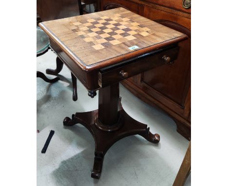 An early 19th century inlaid mahogany games table with square chess board top, octagonal pedestal quatrefoil base and 4 scrol