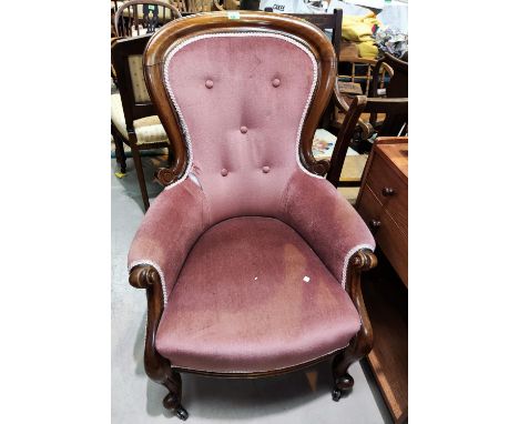 A Victorian mahogany spoon back armchair in buttoned pink dralon 