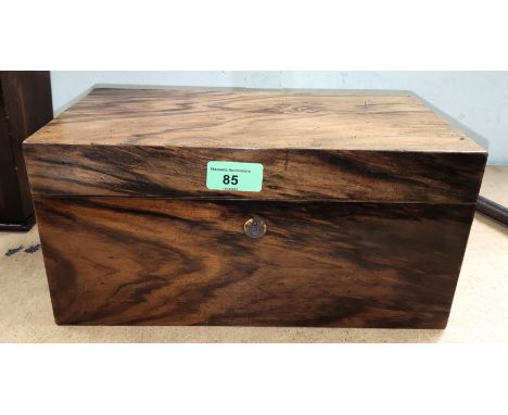 A 19th century figured walnut tea caddy with 2 divisions and central mixing section 