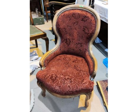 A Victorian style spoon back armchair in dark red; a cane back armchair with floral seat 