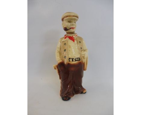 A pottery whisky decanter in the form of a man smoking a pipe. 