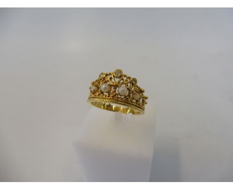 An unusual yellow metal, probably gold ring, ring in the form of a crown inset with small diamonds and seed pearls, weight ap