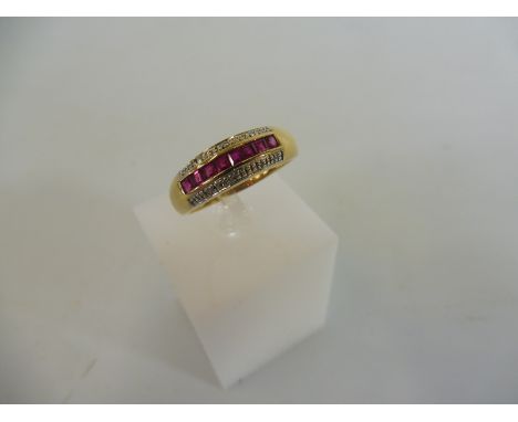 A 9ct gold ruby and diamond channel ring, weight approx. 2g.