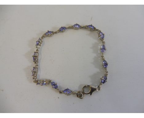 A silver bracelet set with tanzanite.