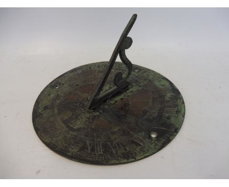 A patinated brass/bronze sundial, 7" diameter.