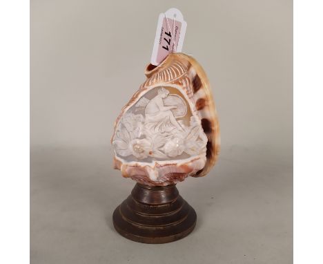 A cameo carved conch shell on wood base and fitted as a lamp, 6 1/5" high