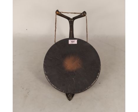 An Art Nouveau metal gong on a wall bracket with coppered finish