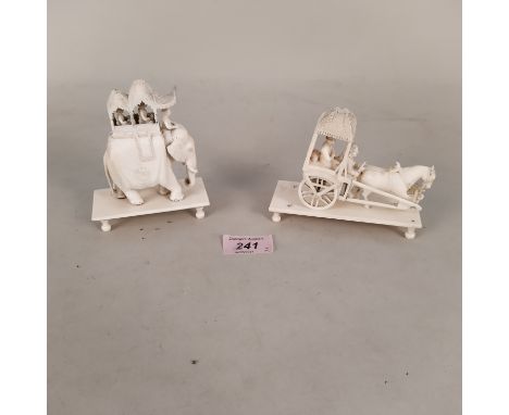 A Chinese carved ivory processional elephant with figures on top standing on a base with turned feet plus a Chinese carved iv