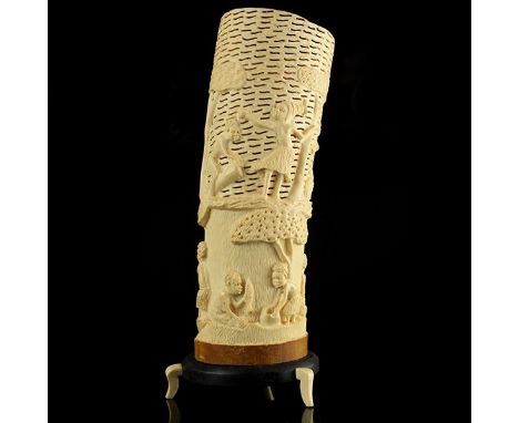 Carved African Ivory Lamp Shade. Hand carved with typical African scenes. Set on a wooden base raised on three ivory supports