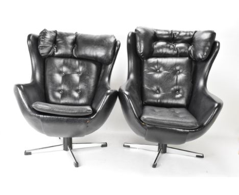 Two Parker Knoll 1980s retro Arne Jacobsen style children's swivel chairs, each with black leather button back upholstery and