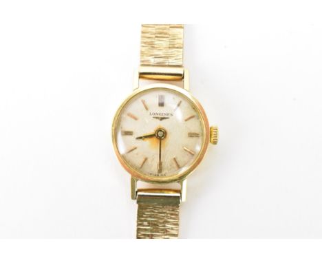 A Longines, manual wind, ladies, 9ct gold wristwatch, the circular silvered dial having gilt baton markers, fitted with a 9ct