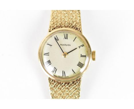 A Marvin, manual wind, ladies, 9ct gold wristwatch, the silvered dial having Roman numerals, fitted with an integral 9ct gold
