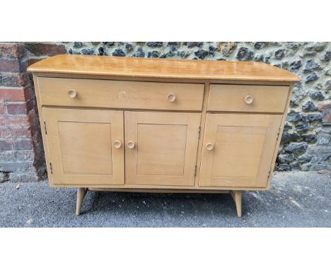 A 1960s Ercol blonde elm and beech sideboard model 351, designed by Lucian Ercolani, having two drawers above three cupboard 