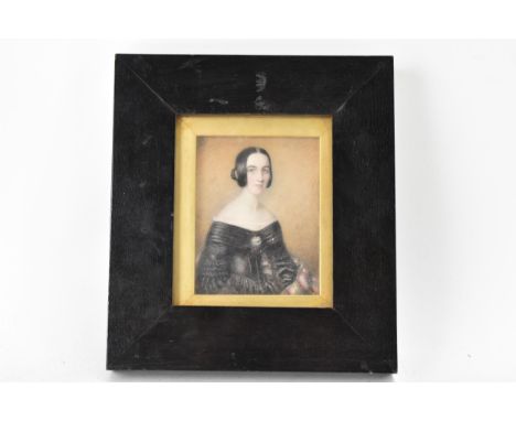 A 19th century portrait miniature on ivory depicting a lady in a black dress, inscribed to the reverse 'Wife of the Rev Georg