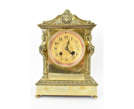 A late 19th century French gilt metal mantle clock, the case of architectural form with two putti flanking the circular dial 