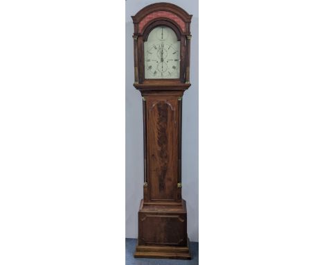 An early 19th century mahogany 8 day longcase clock, having an arched top with pierced grille above reeded columns flanking t