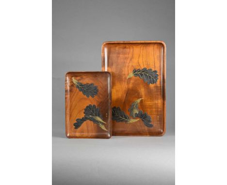 Two Japanese lacquered wood trays, Taisho era or laterof rectangular form with rounded corners, the shallow trays with rich b