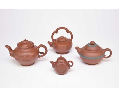 Four Chinese Yixing teapots, 20th century, of reddish brown colour, one moulded with prunus branch handle, finial and spout, 