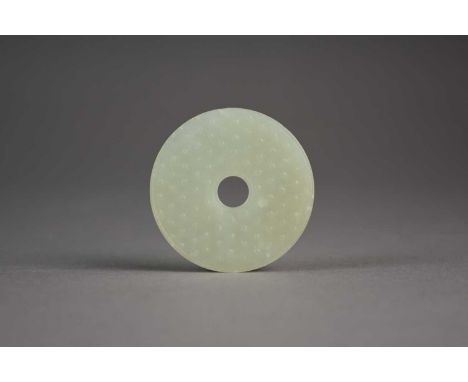 A Chinese pale green jade bi disc, Ming DynastyOf circular form and carved to one side with circles, to the other side with e