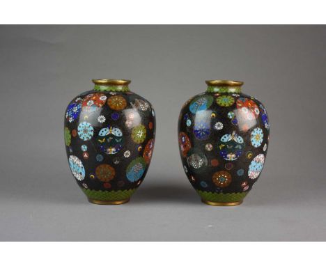 A pair of Japanese cloisonne vases, Meiji eraOf ovoid form with everted rims, decorated with scattered roundels of stylised f