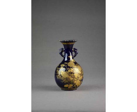 A Japanese Satsuma vase, Meiji eraOf bottle form with twin dragon handles, decorated in raised gilt with birds amid flowering
