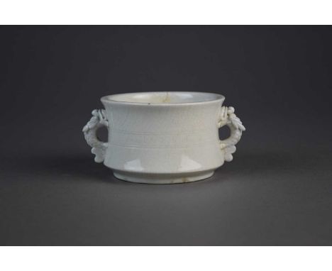 A Chinese Dehua white 'soft paste' censer, probaby KangxiOf wasted cylindrical shape with twin leaping fish handles, incised 