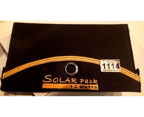 New old stock, 12 watt folding solar panel pack with two USB charging outputs. Integral part of case with magnetic catch and 