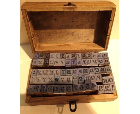 An oak lidded case containing mainly letter stamps. P&amp;P Group 1 (£14+VAT for the first lot and £1+VAT for subsequent lots