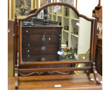 A mahogany dressing mirror, shaped arched mirror, acorn finials, spreading uprights, cabriole supports, circa 1900.