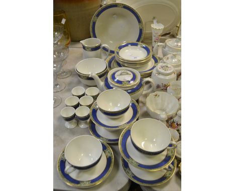 A Grindley Goodwood pattern part-dinner and tea service, decorated with a cobalt blue band and green floral sprays