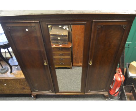 A mahogany triple wardrobe, central mirror, carved frieze to top, cabriole legs c.1930