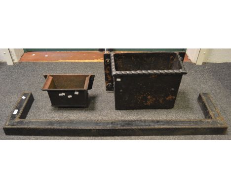 A Victorian cast iron drain hopper and another smaller; a cast fender