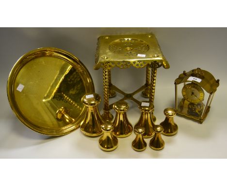 A graduated set of six Avery weights, 7lb - 1lb;  a brass trivet;   a Shultz brass mantel clock