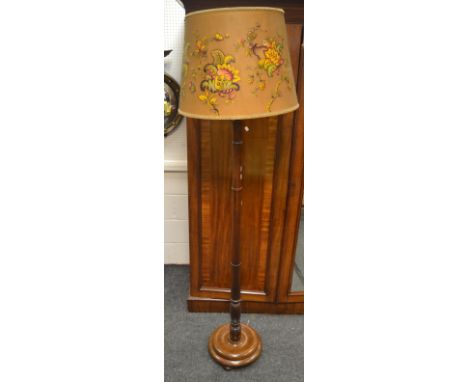 An early 19th century oak standard lamp, spreading ribbed cylindrical column, circular base.