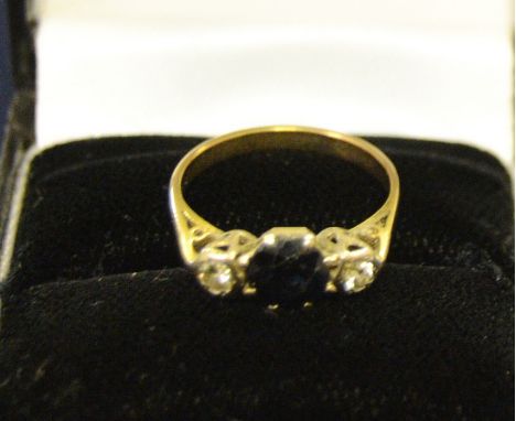 A sapphire and diamond three stone ring