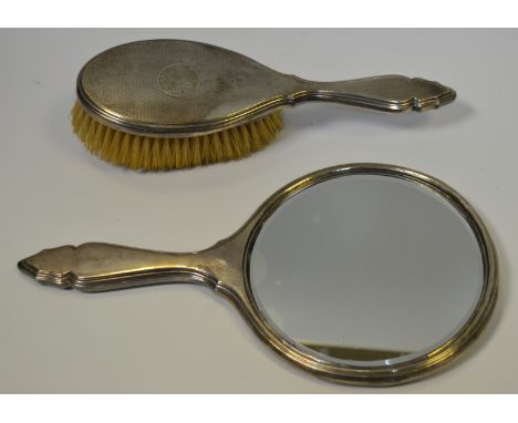 Silver - a silver backed, engine turned hand mirror; clothes brush; Chester (marks rubbed)