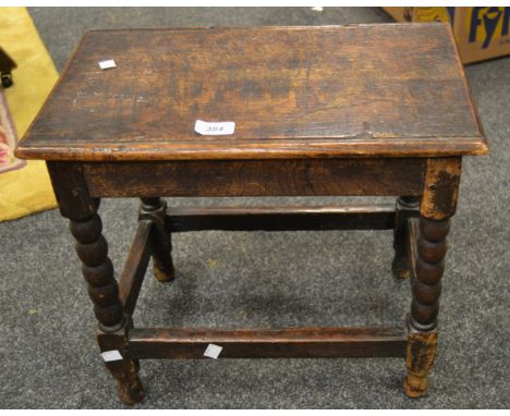 An 18th century oak joint stool, rectangular top, bobbin turned legs, black stretcher, 45cm wide