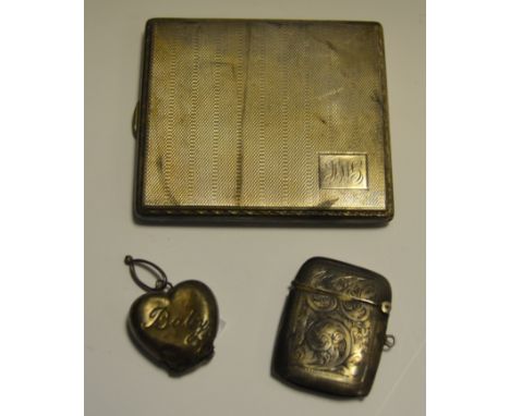 A silver cigarette case, engine turned;  a silver vesta case;  a silver heart shaped rattle, 5oz