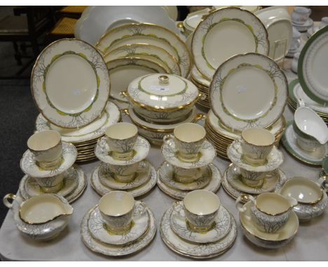 A Crown Devon dinner service, for twelve, comprising two tureens, three graduated meat plates, dinner plates, salad plates, t