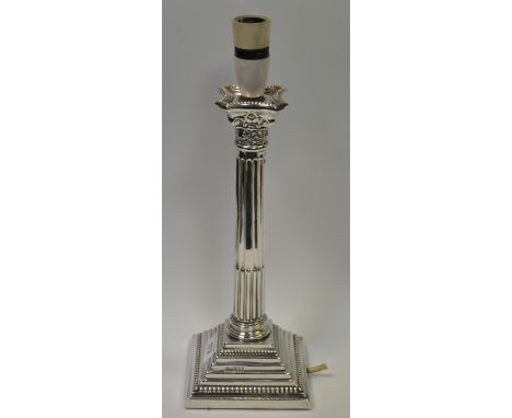 A silver Corinthian column candlestick, stop fluted columns, stepped base, beaded borders, 31cm high, Birmingham contemporary