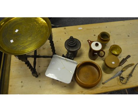 An eastern brass charger table, with stand; a large set of scales; a white metal decorative eastern pipe; a Poole treacleware